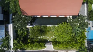 Stunning Communal House Inspired Red Villa Amidst Lush Greenery in Ho Chi Minh City - image 3