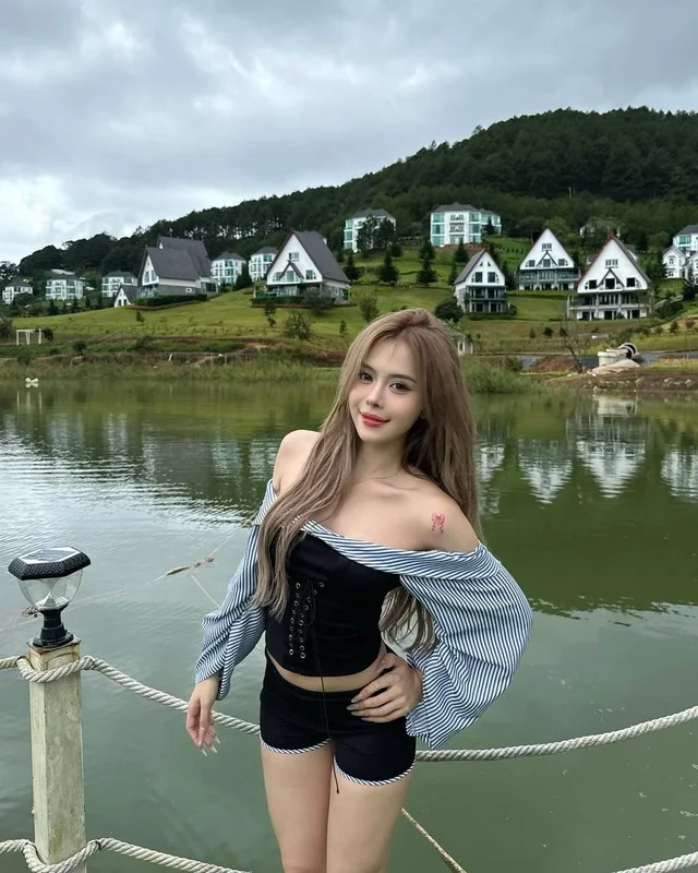 Popular TikToker Captivates Fans with Elegant Deep-Neck Dress and Unique Beauty Mark