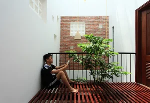 Innovative West-Facing House Design with Hollow Brick Facade - image 1