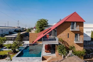 Discover the Unique Laterite Stone House with an Innovative Folding Roof in Saigon - image 2