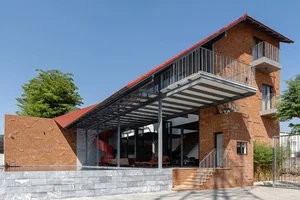 Discover the Unique Laterite Stone House with an Innovative Folding Roof in Saigon - image 8