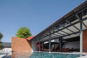 Discover the Unique Laterite Stone House with an Innovative Folding Roof in Saigon - image 5