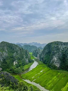 Admire the Breathtaking Beauty of Tam Coc During the Vibrant Green Rice Season - image 0