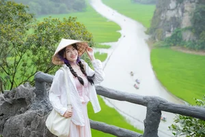 Admire the Breathtaking Beauty of Tam Coc During the Vibrant Green Rice Season - image 6
