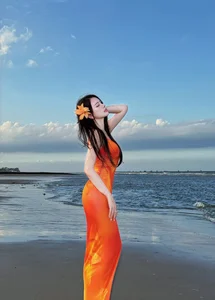 Thu Thuy Radiates in Vibrant Orange: Summer Fashion Inspiration by the Sea - image 8