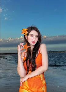 Thu Thuy Radiates in Vibrant Orange: Summer Fashion Inspiration by the Sea - image 9