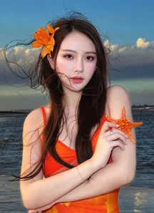 Thu Thuy Radiates in Vibrant Orange: Summer Fashion Inspiration by the Sea - image 1